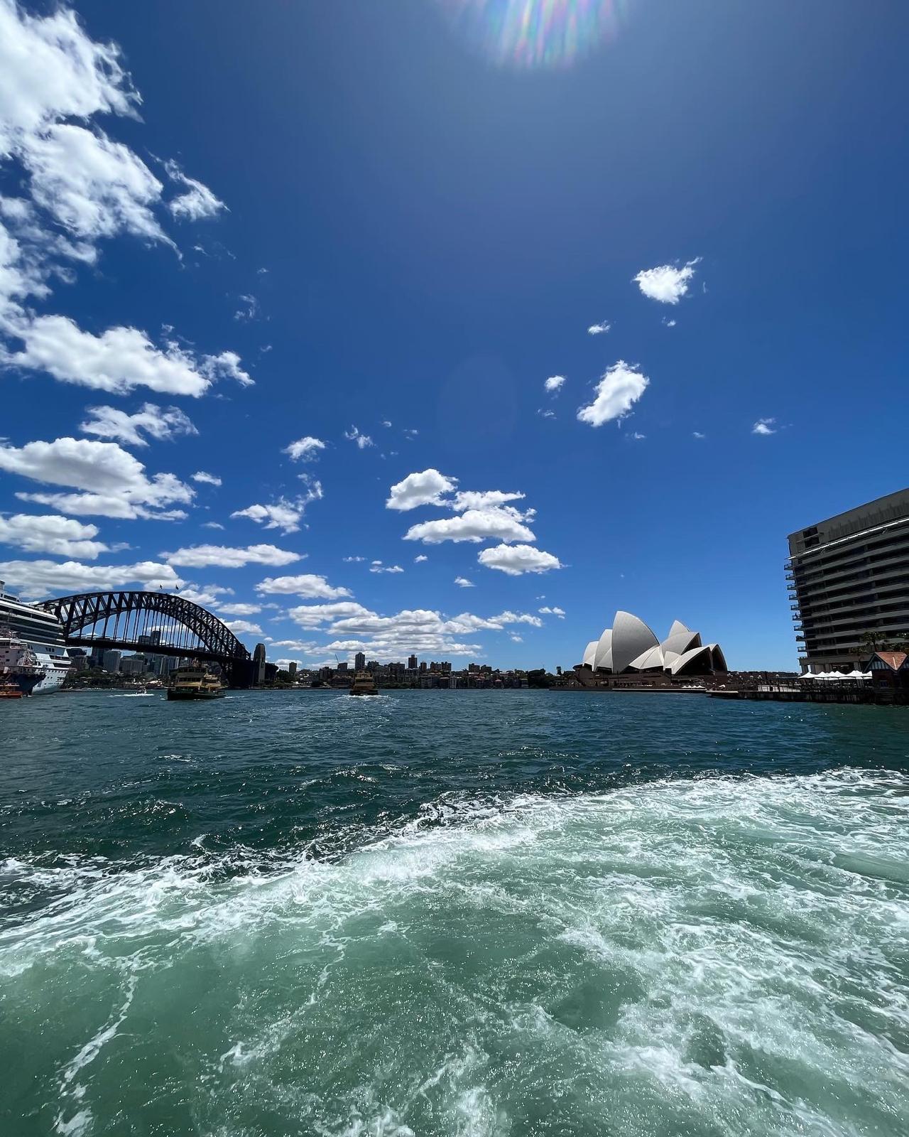 Sydney Harbour with the Harbour Bridge and Sydney Opera House visible from the water.