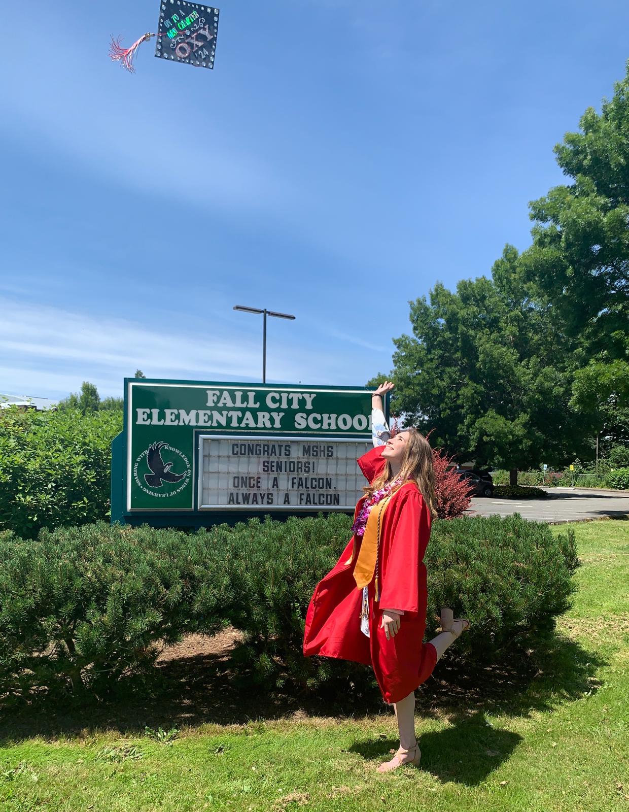 High school graduation portrait in Fall City, Washington, with a school sign in the background.